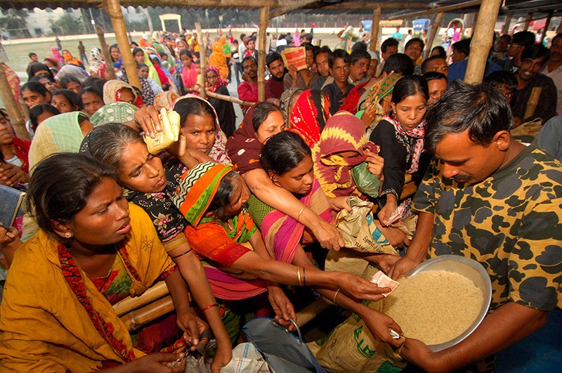 Un gruppo di donne lotta per ottenere il riso a Dhaka, in Bangladesh